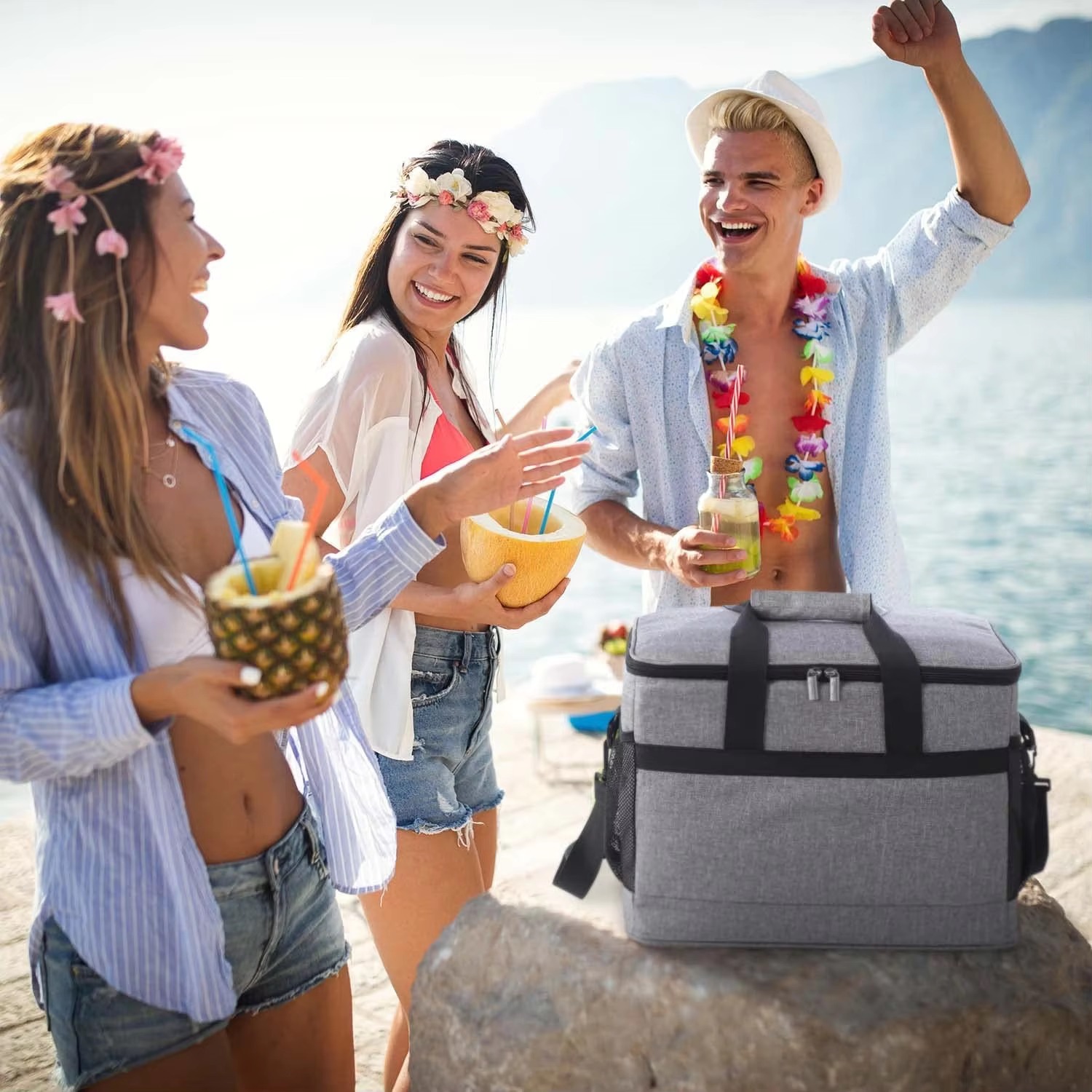 friends using the cooler bag on a rocky beach