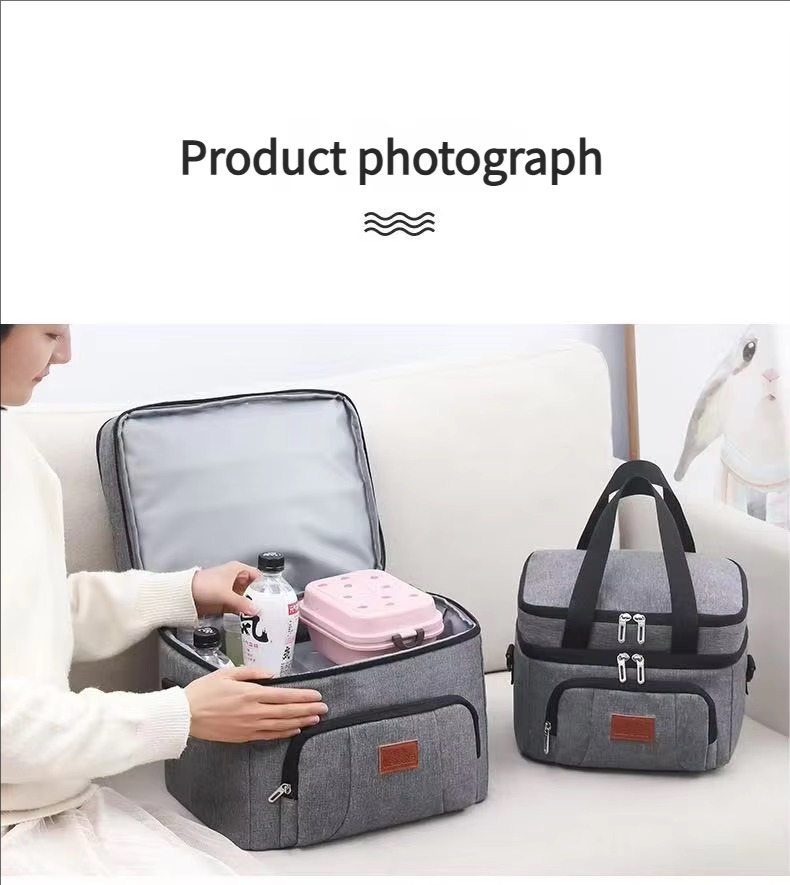 two-tier cooler bag opened with canned drinks and lunch box on sofa