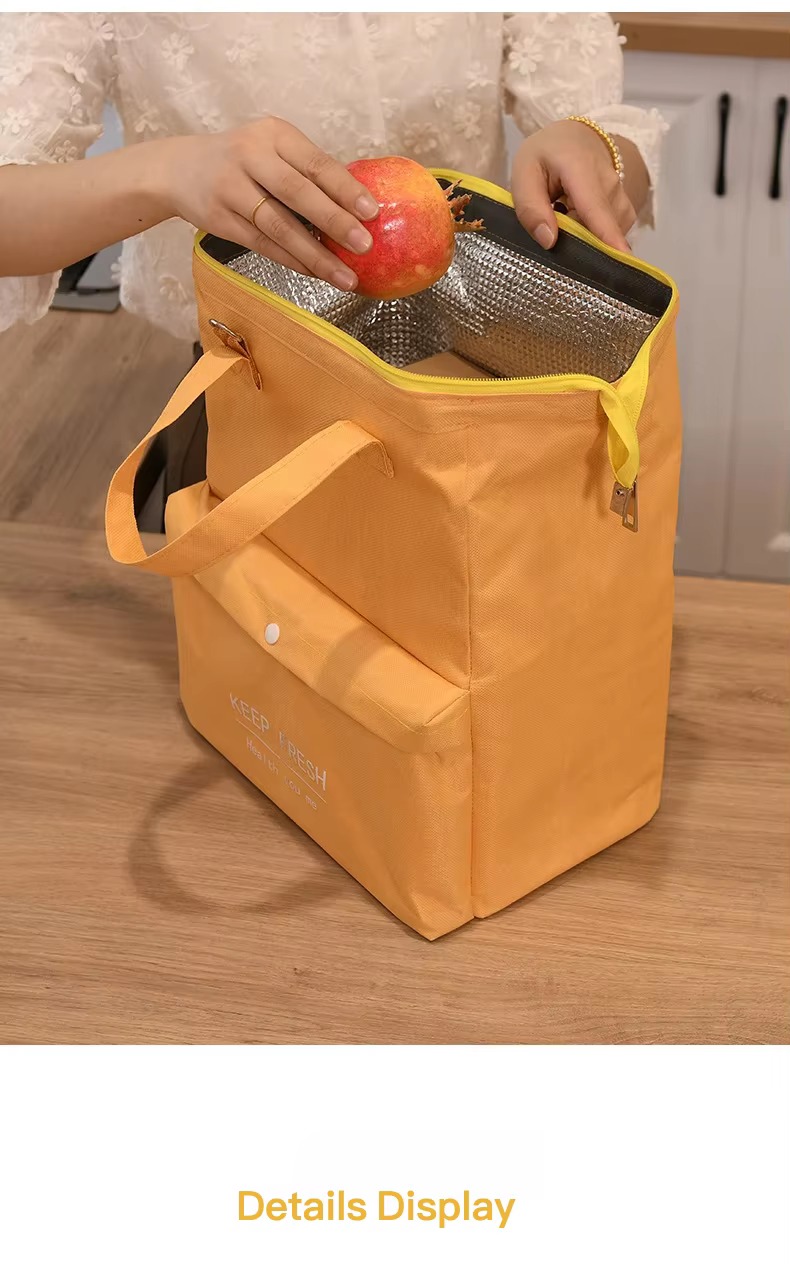 hands putting fruit into open lunch bag