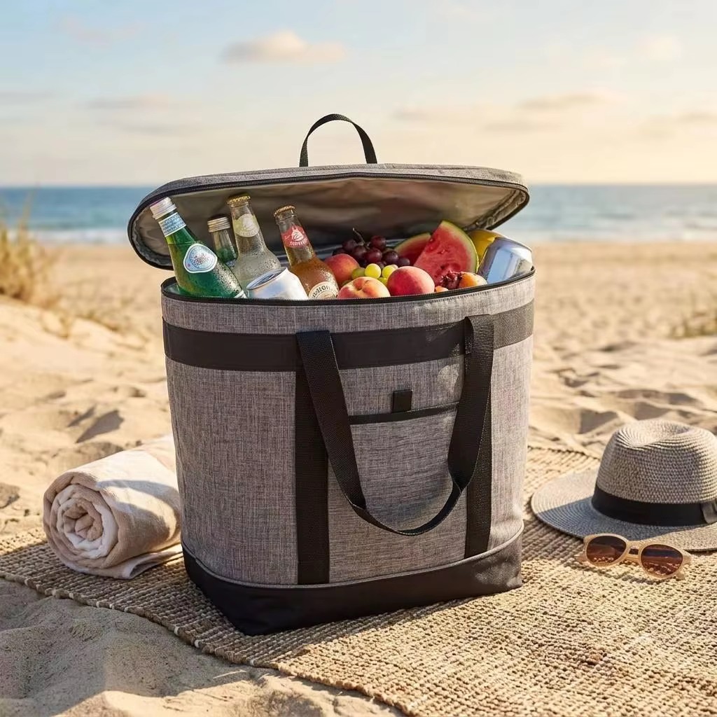 cooler tote packed with drinks and fruit on a beach blanket