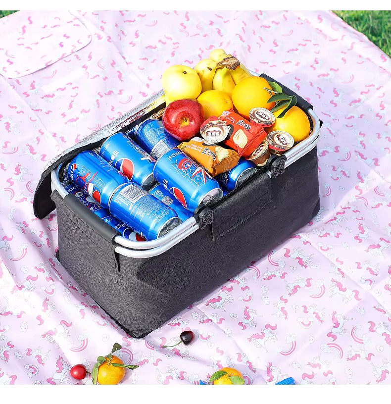 basket filled to the brim with drinks, fruit, and snacks
