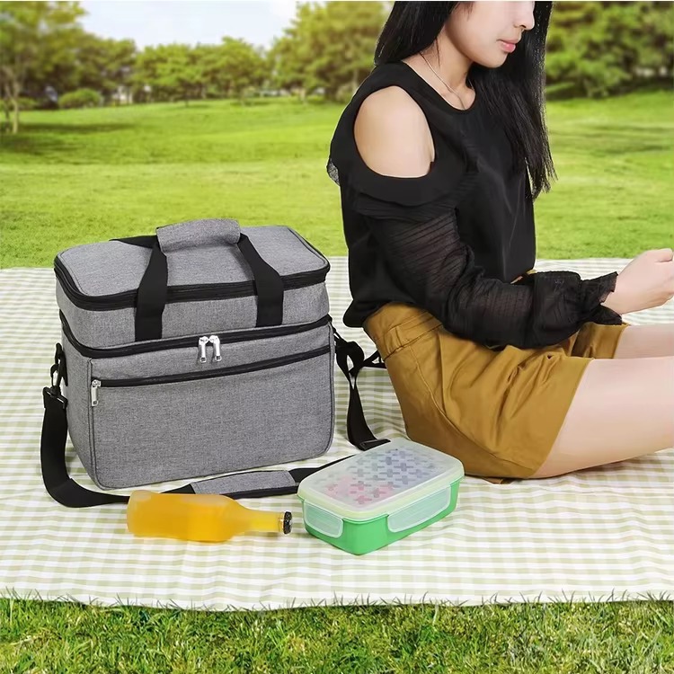 cooler bag on a picnic blanket with a drink bottle and lunch container