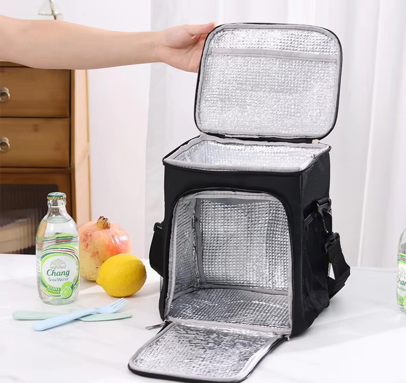 front compartment open showing foil lining with fruit and drink bottles