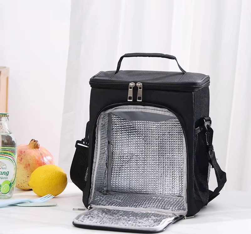 black bag held by carry handle showing front pocket
