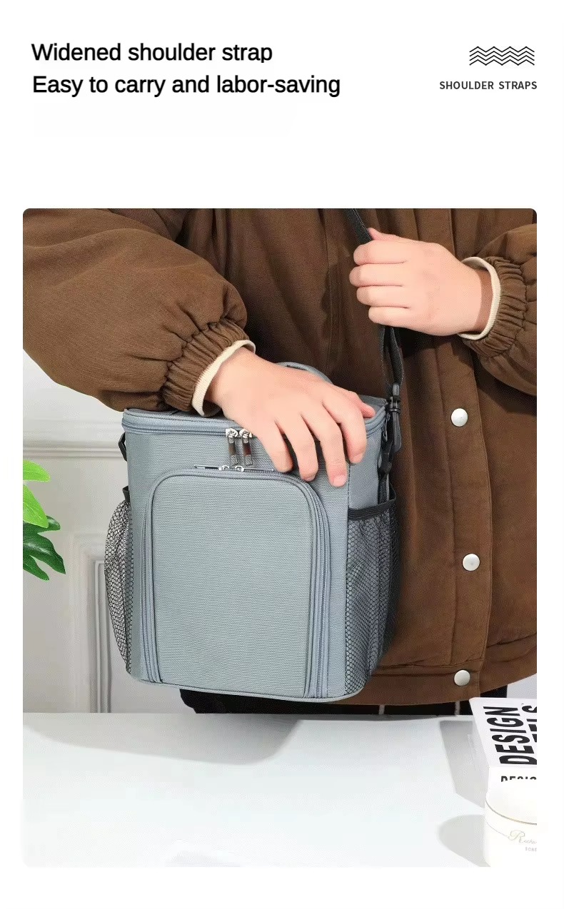 widened shoulder strap worn cross-body by a model holding the gray bag