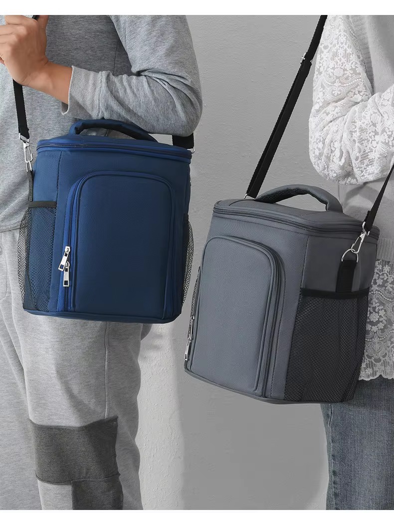 navy blue and gray bags worn cross-body by two models