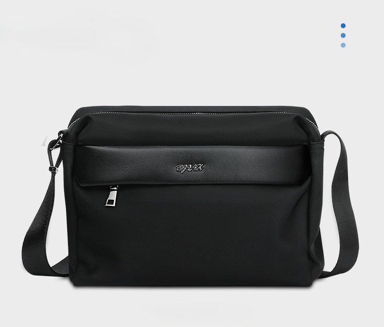 front three-quarter view of black bag with leather trim panel