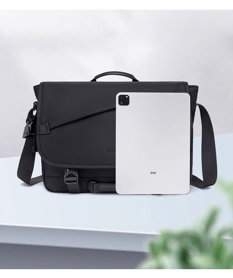 black bag beside an iPad for size comparison