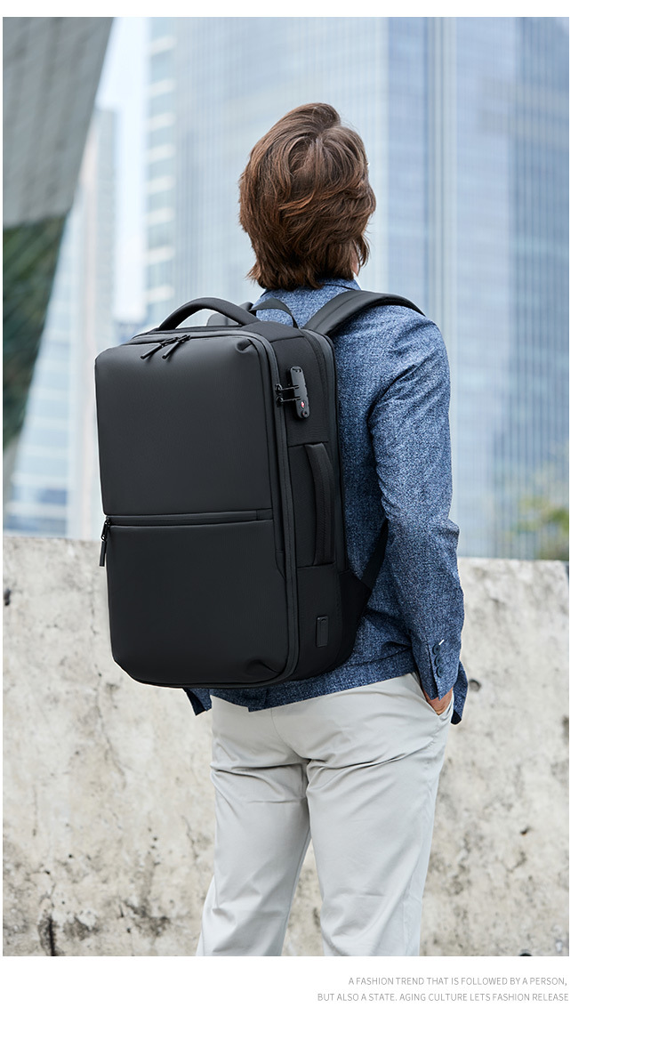 model wearing the backpack from behind in a city setting