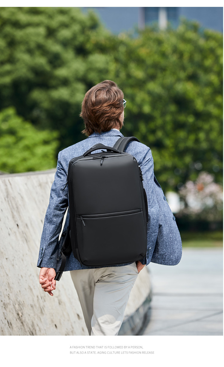 model walking away wearing the backpack outdoors