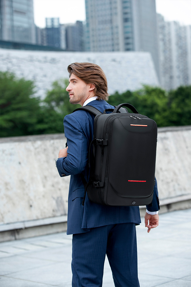 man in a suit wearing the backpack outdoors on a stone plaza
